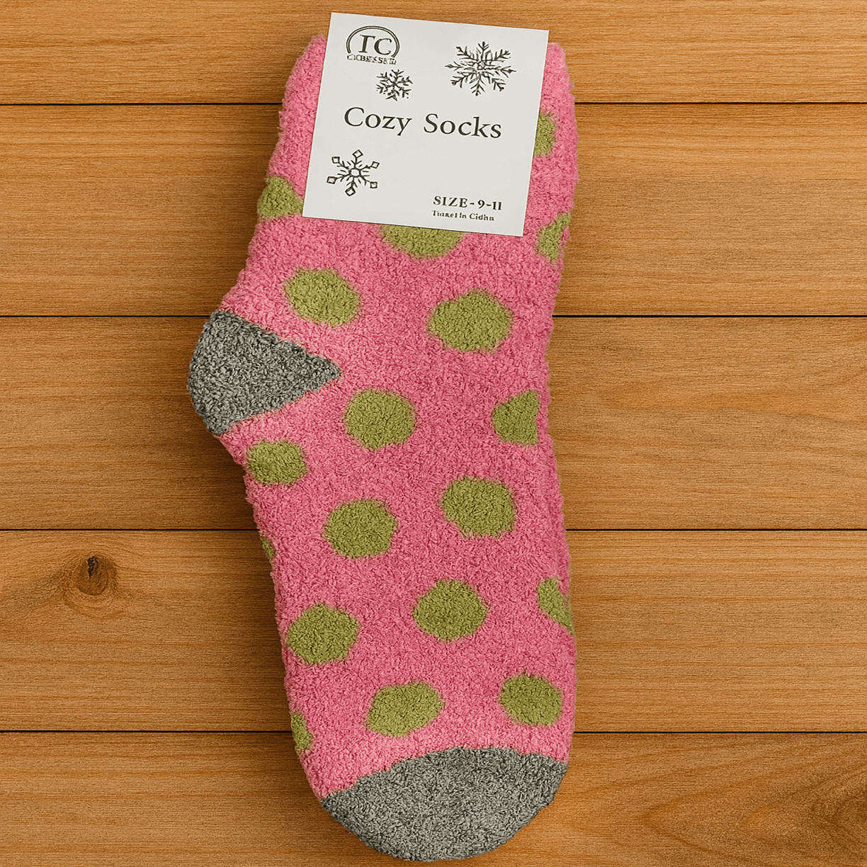 Pink fuzzy socks with green polka dots, cozy and soft, perfect for lounging and warm comfort.