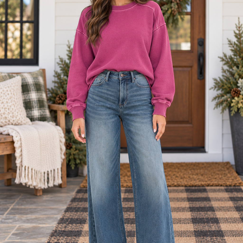 Model showcasing JUDY BLUE - LIZA high-waisted palazzo jeans with a pink sweatshirt outdoors.