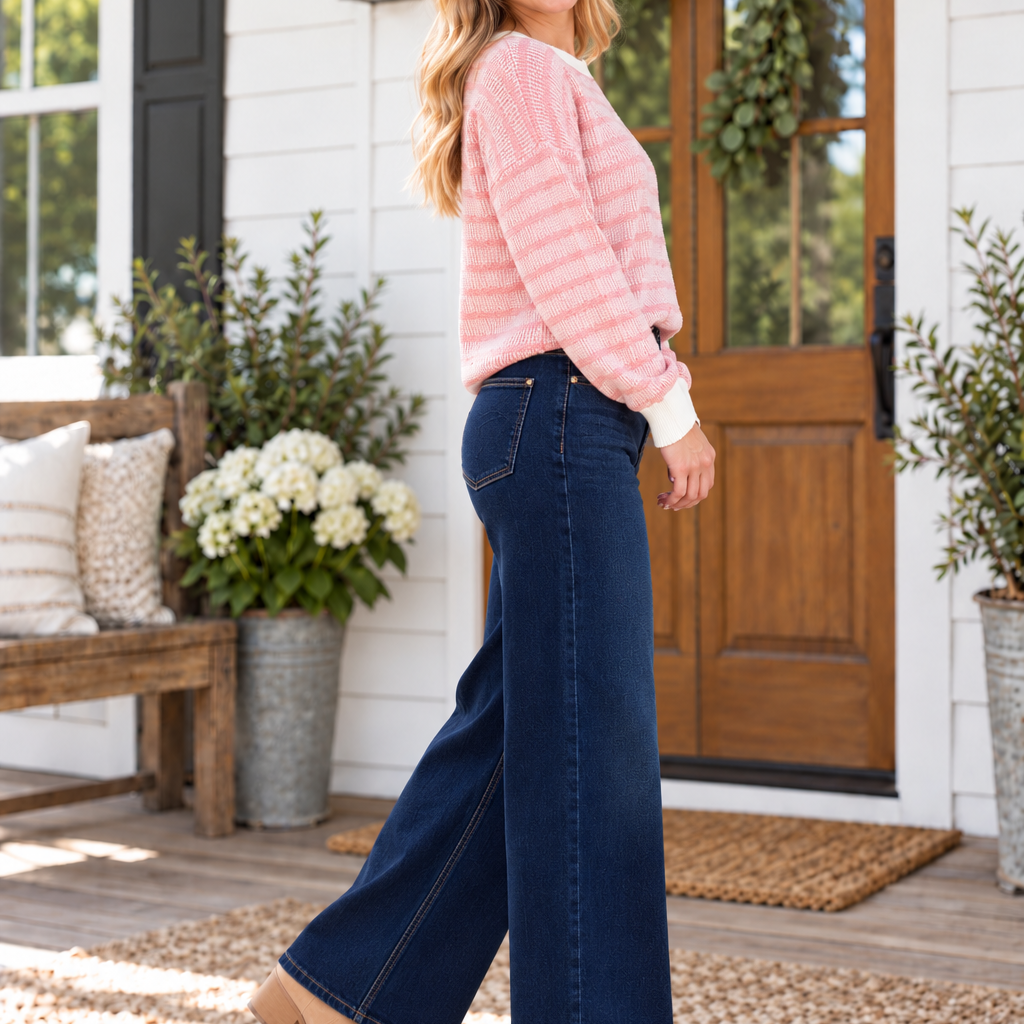 JUDY BLUE - GRACIE wide-leg jeans in Dark Twilight Blue, styled with a pink sweater and set against a cozy outdoor backdrop.