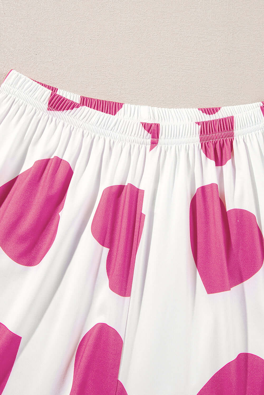 Close-up of pink heart-print lounge pants, part of the Love Language Lounge Set, showcasing a playful and cozy design.
