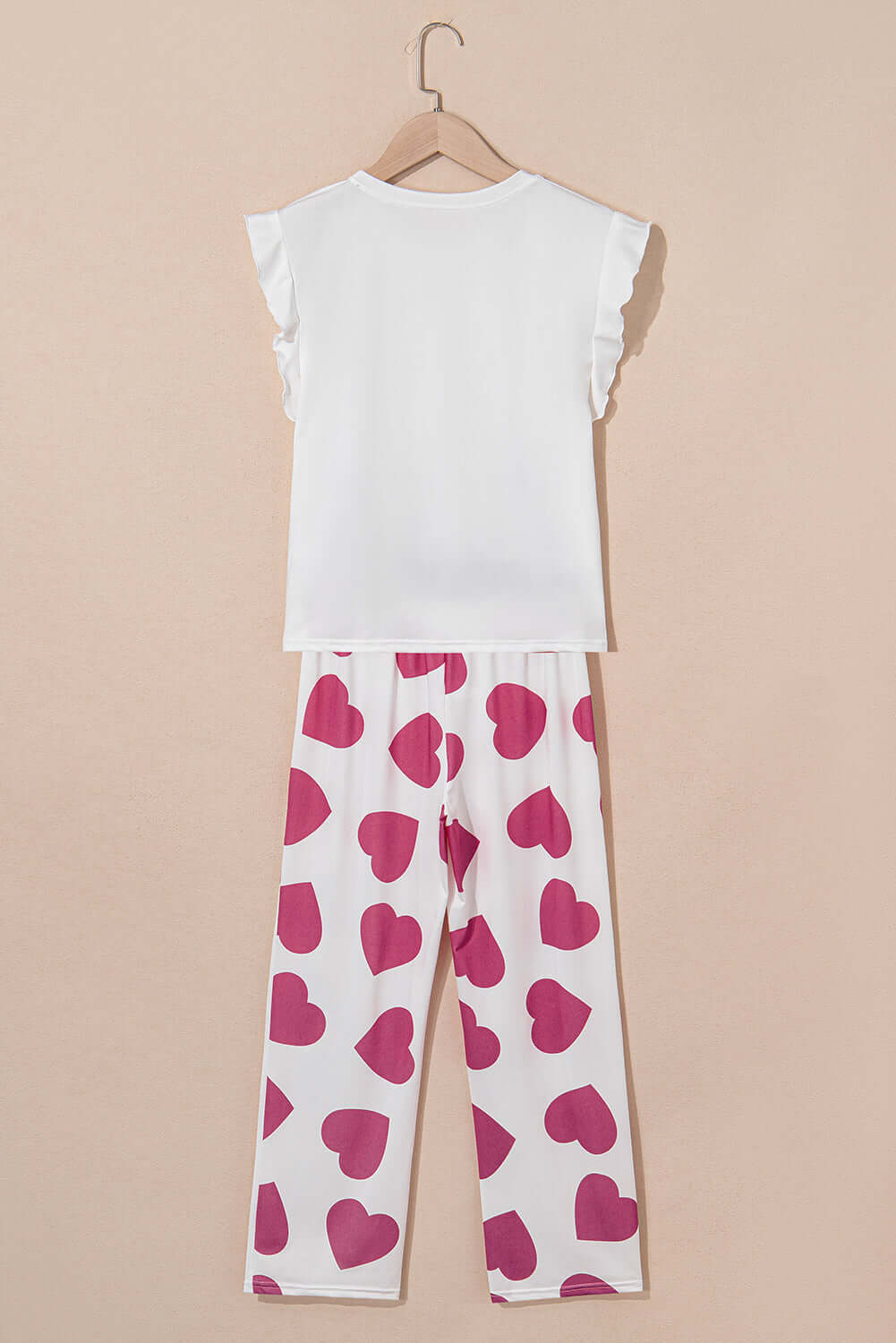 Love Language Lounge Set in pink featuring a ruffled tank top and heart-print lounge pants, ideal for cozy relaxation.