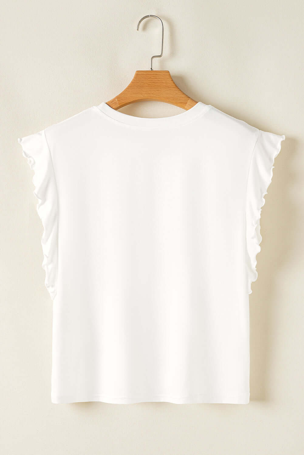 Back view of a white ruffled sleeve top hanging on a wooden hanger, showcasing its stylish design.