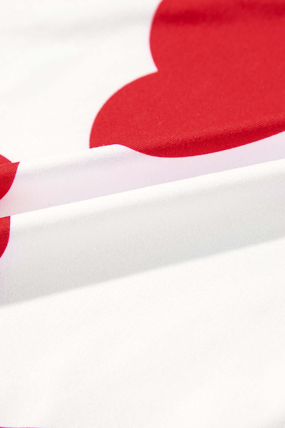 Close-up of soft fabric featuring playful red heart prints, perfect for the Love Language Lounge Set.