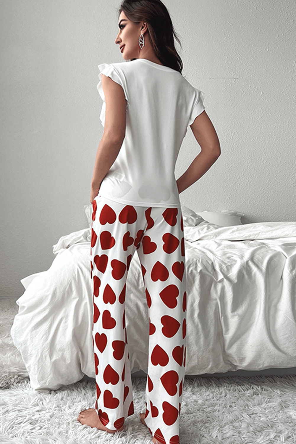 Model showcases the Love Language Lounge Set with heart-print lounge pants and a relaxed fit top.