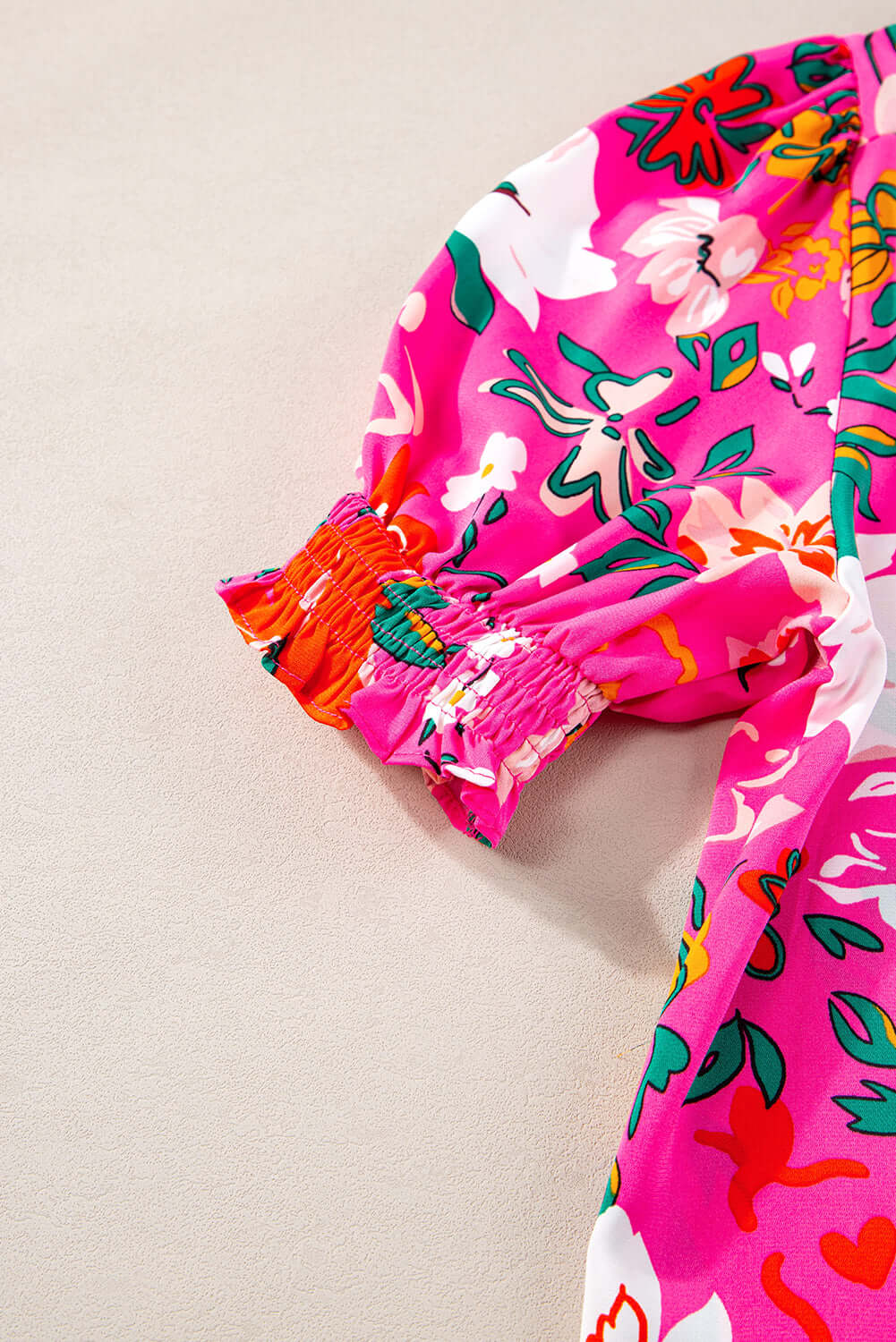 Close-up of Paradise Petals top showcasing vibrant rose floral print and puff sleeve detail.