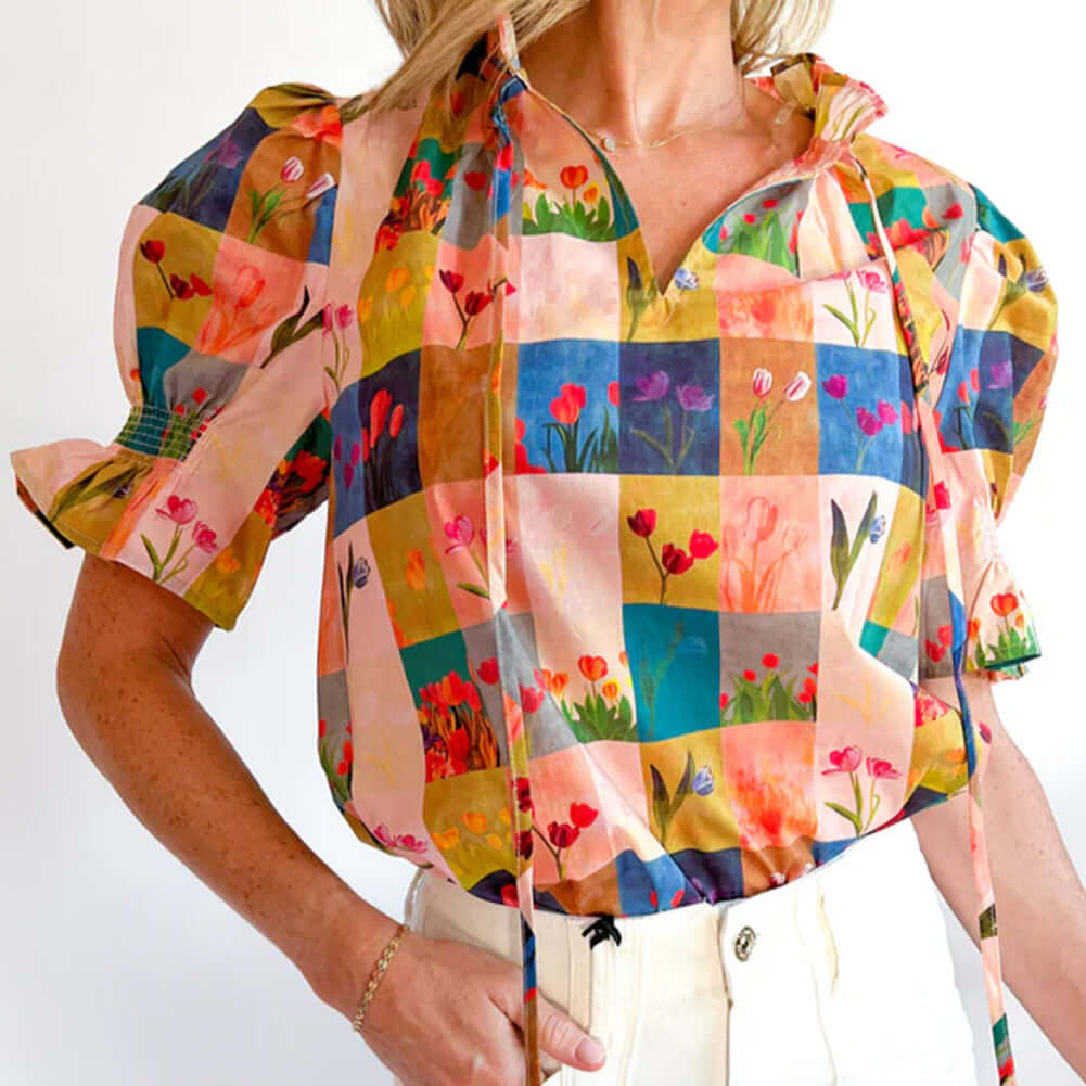 Colorful floral checker print blouse with puff sleeves, perfect for a vibrant garden-inspired look.