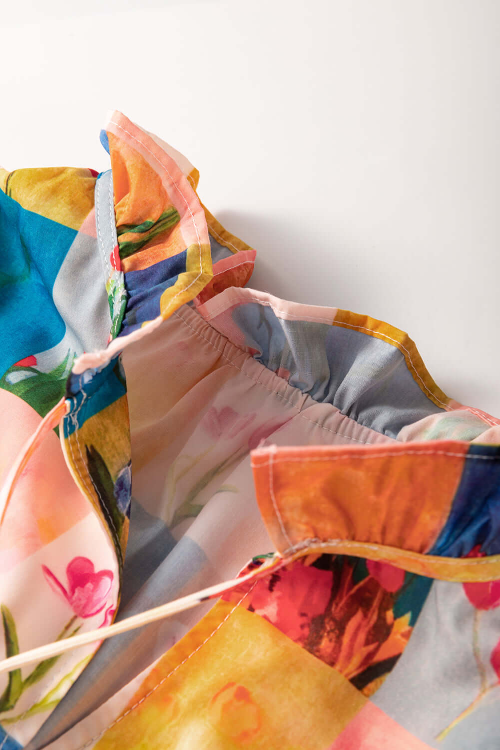 Colorful floral and checker print of Garden Window Top blouse showcasing vibrant design and lightweight style.