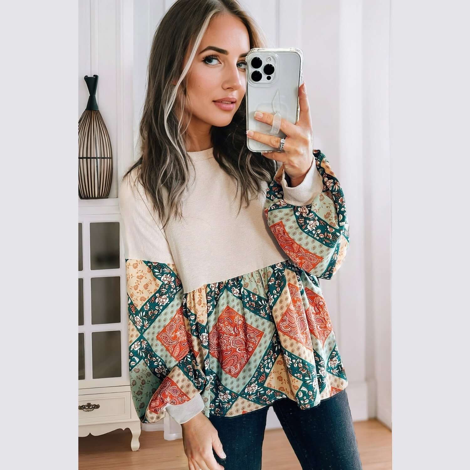 Model wearing a PATCHWORK POETRY TOP showcasing a geometric patchwork design with bubble sleeves and a cozy fit.