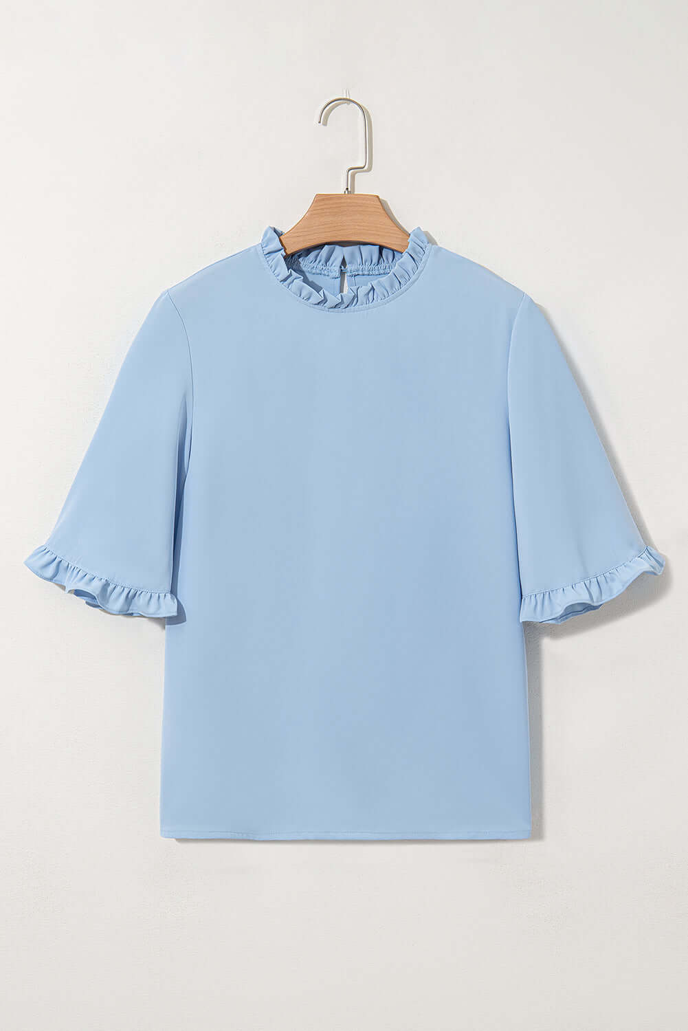 Frill Seeker Top in sky blue, featuring ruffle trim and wide half sleeves for a chic, relaxed look.