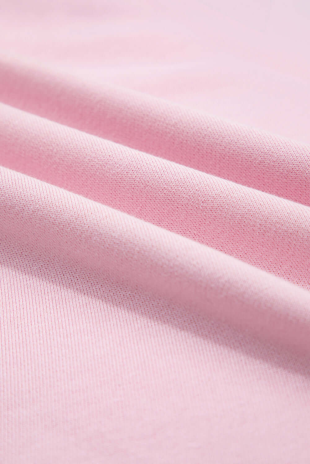 Close-up of soft pink fabric showcasing the texture of the SWEET ESCAPE TOP.