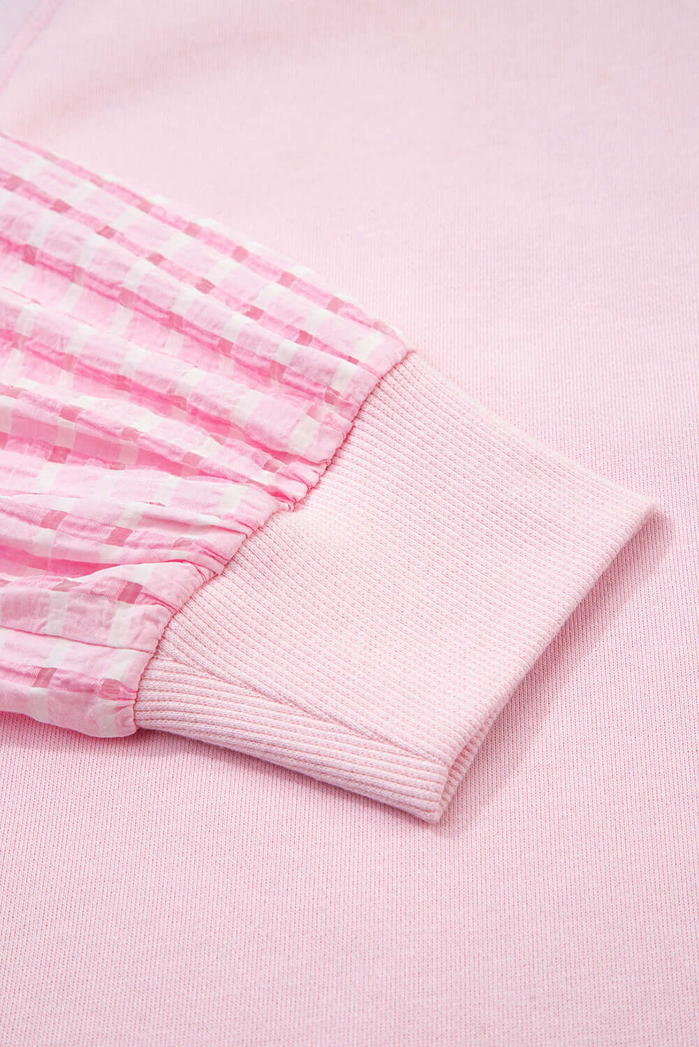 Close-up of the SWEET ESCAPE TOP showcasing pink puff sleeve and ribbed cuff detail.