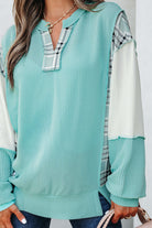 AQUA AVENUE TOP featuring a soft ribbed texture and playful plaid patchwork design, perfect for everyday wear.