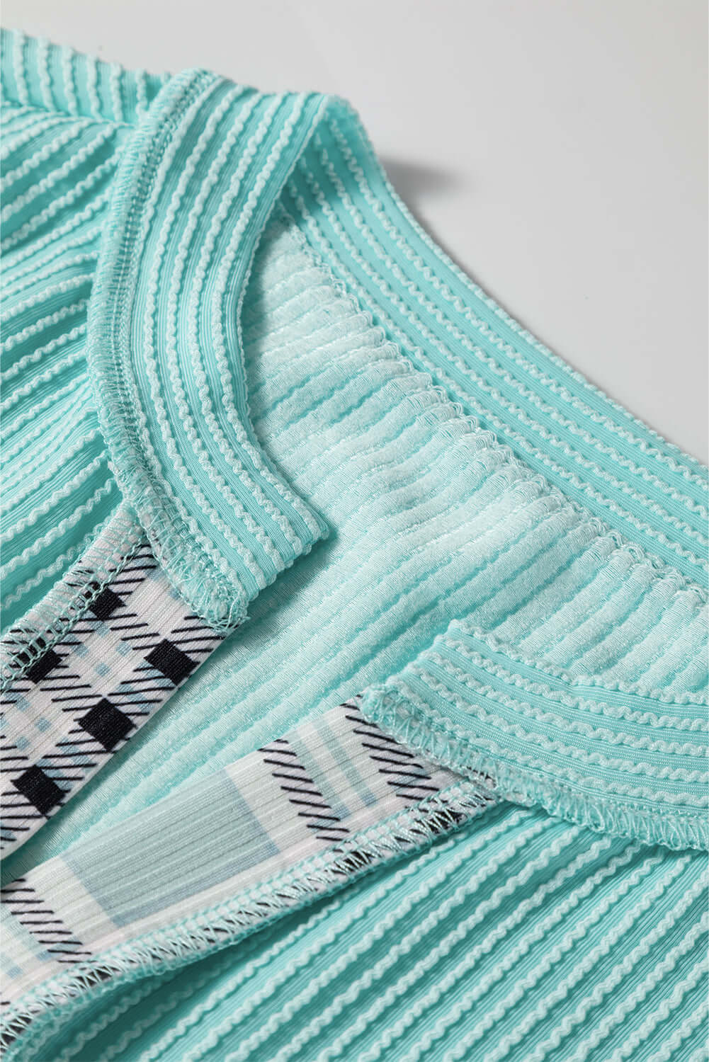 AQUA AVENUE TOP close-up showcasing the ribbed texture and colorful patchwork design for a stylish look.