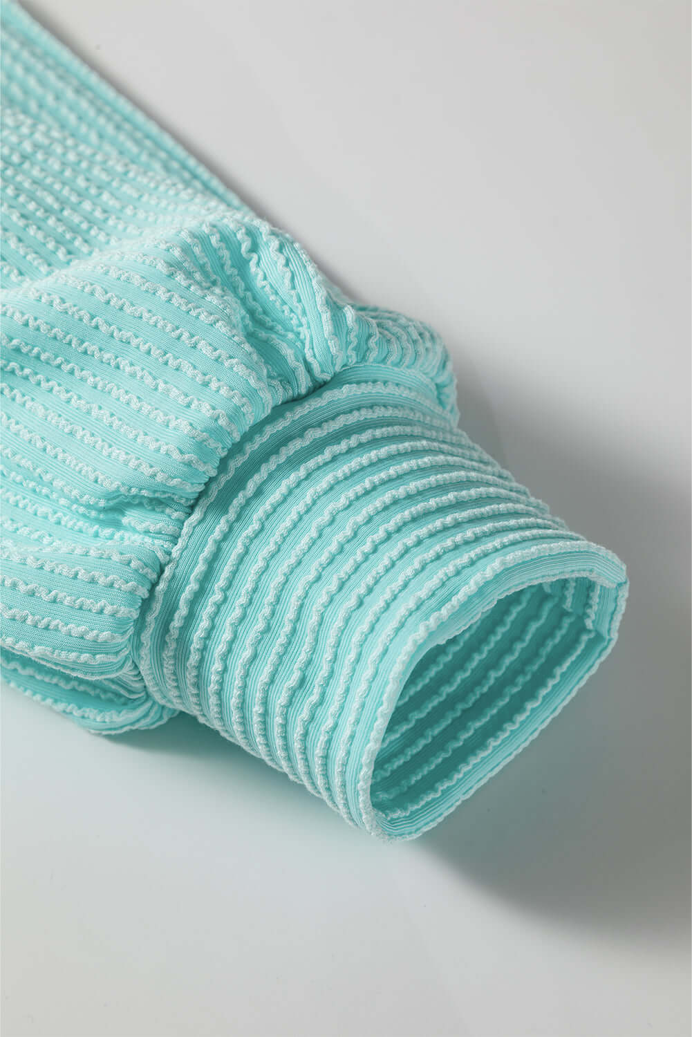 Close-up of the AQUA AVENUE TOP ribbed texture showcasing soft, corded fabric detail in mint green.