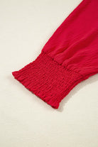 Close-up of the shirred sleeve of the TRUE PASSION TOP in fiery red, highlighting its stylish design and comfort.