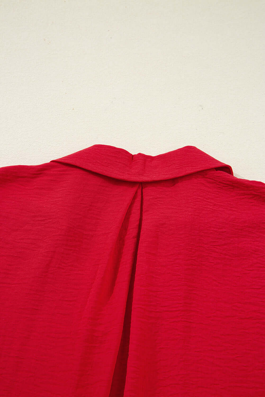 Back view of the TRUE PASSION TOP in fiery red showcasing the collar and unique shirred design.