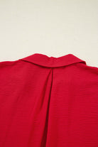 Back view of the TRUE PASSION TOP in fiery red showcasing the collar and unique shirred design.