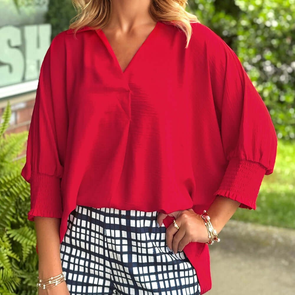 TRUE PASSION TOP in fiery red, featuring a V-neck and 3/4 shirred sleeves, paired with stylish checkered pants.