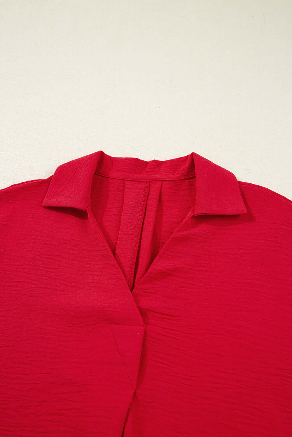 TRUE PASSION TOP in fiery red with a flattering V-neck and collared detail, showcasing chic comfort and style.