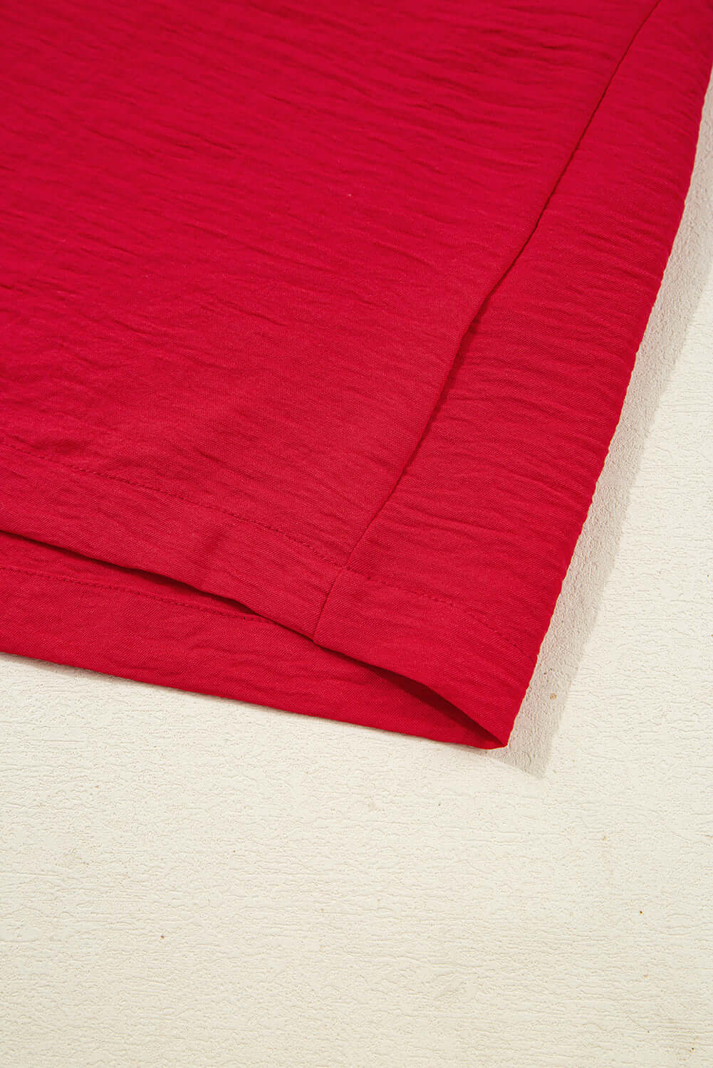 TRUE PASSION TOP in fiery red, showcasing the soft fabric and shirred sleeve detail.