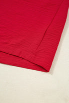 TRUE PASSION TOP in fiery red, showcasing the soft fabric and shirred sleeve detail.