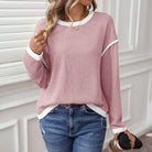 Woman wearing a BLUSHLINE BEAUTY TOP in soft blush with contrast trim, styled with casual jeans for a relaxed look.
