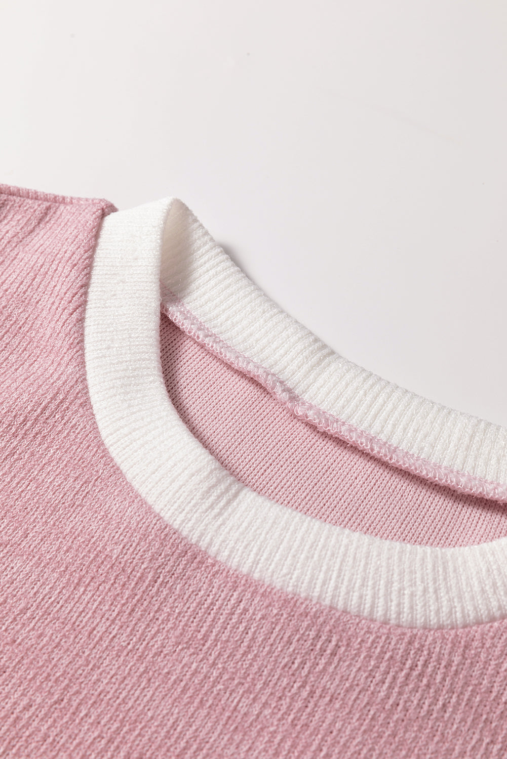 Close-up of the collar of the BLUSHLINE BEAUTY TOP showcasing soft knit texture and chic contrast trim.