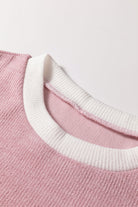 Close-up of the collar of the BLUSHLINE BEAUTY TOP showcasing soft knit texture and chic contrast trim.