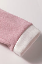 Close-up of the soft knit texture and contrast trim of the BLUSHLINE BEAUTY TOP in blush pink and white.