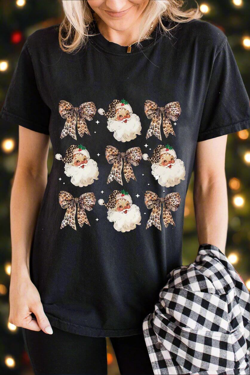 Festive HO HO HO AND BOWS T-shirt featuring leopard print bows and Santa graphics, perfect for holiday celebrations.