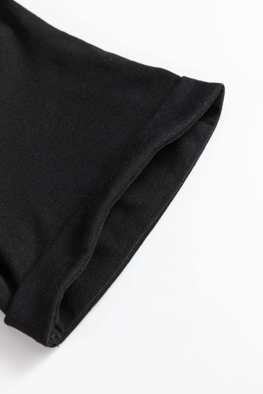 Close-up of the sleeve hem of a comfortable black T-shirt for festive occasions.