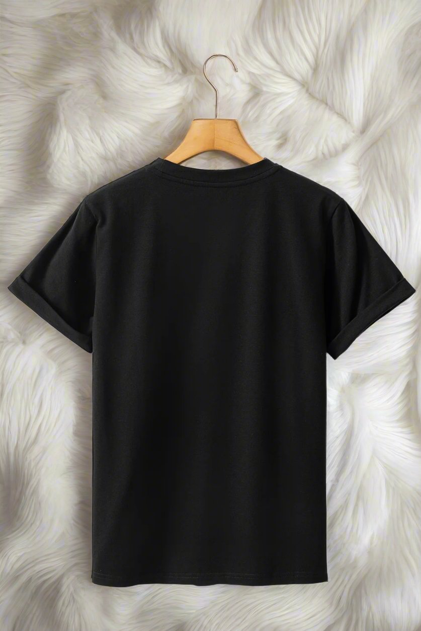 Back view of a black T-shirt on a hanger against a soft white fur background.