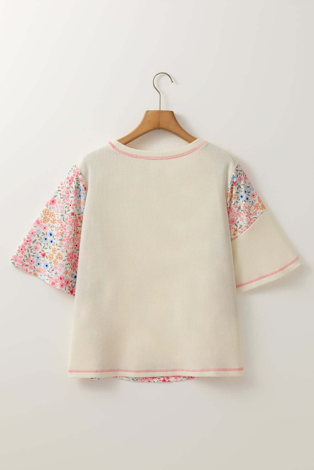 Back view of Porch Swing Petals beige knit top with floral sleeves, perfect for casual outings.