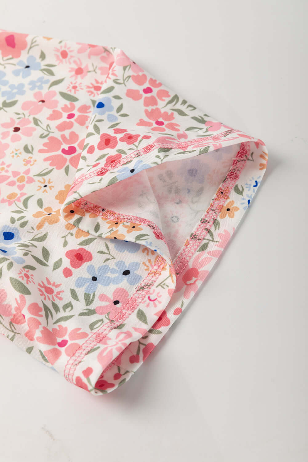Floral print detail of the Porch Swing Petals top showing vibrant colors and relaxed fit.
