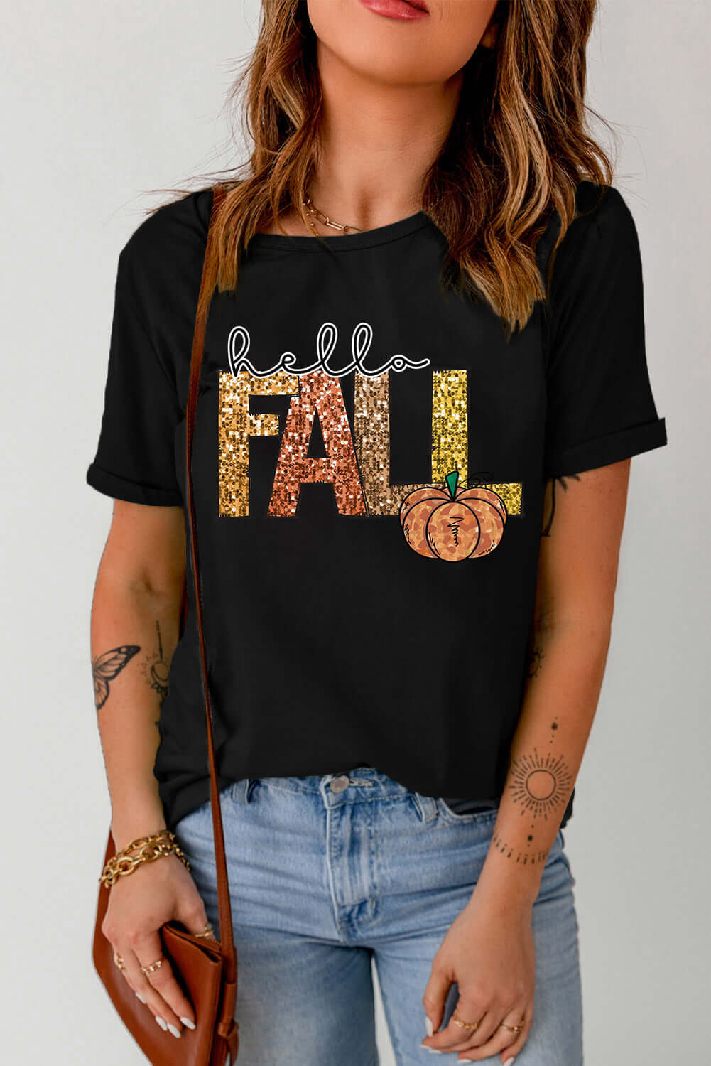 Black HELLO FALL TEE featuring festive lettering and pumpkin graphic, perfect for autumn gatherings.