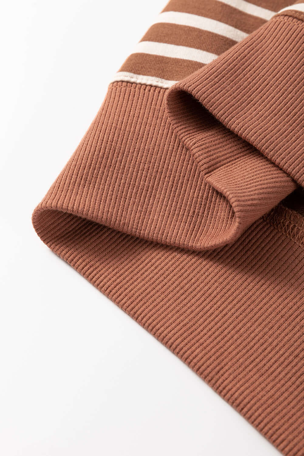 Close-up of MAPLE CIDER CREWNECK TOP showcasing the brown stripe colorblock design and soft, cozy fabric detail.