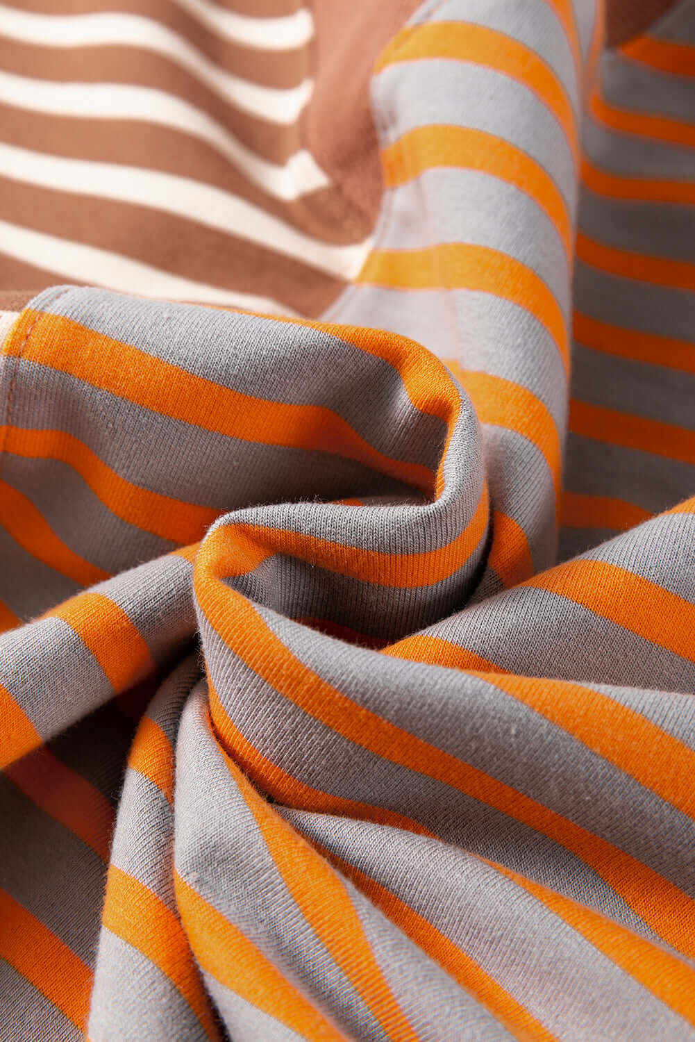 Close-up of striped fabric in orange and gray, showcasing the design of the MAPLE CIDER CREWNECK TOP.