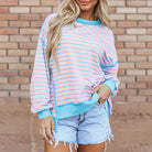 Model wearing the SALTWATER TAFFY TOP with pink and aqua stripes, showcasing a stylish, relaxed look.