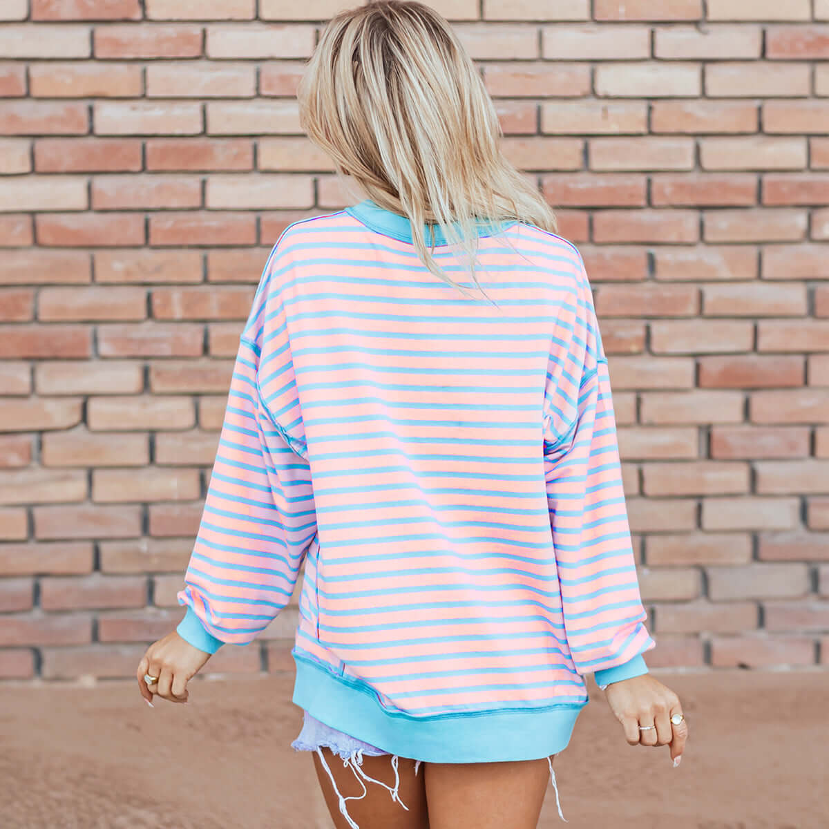 Back view of the SALTWATER TAFFY TOP in soft pink and aqua stripes with contrast trim.
