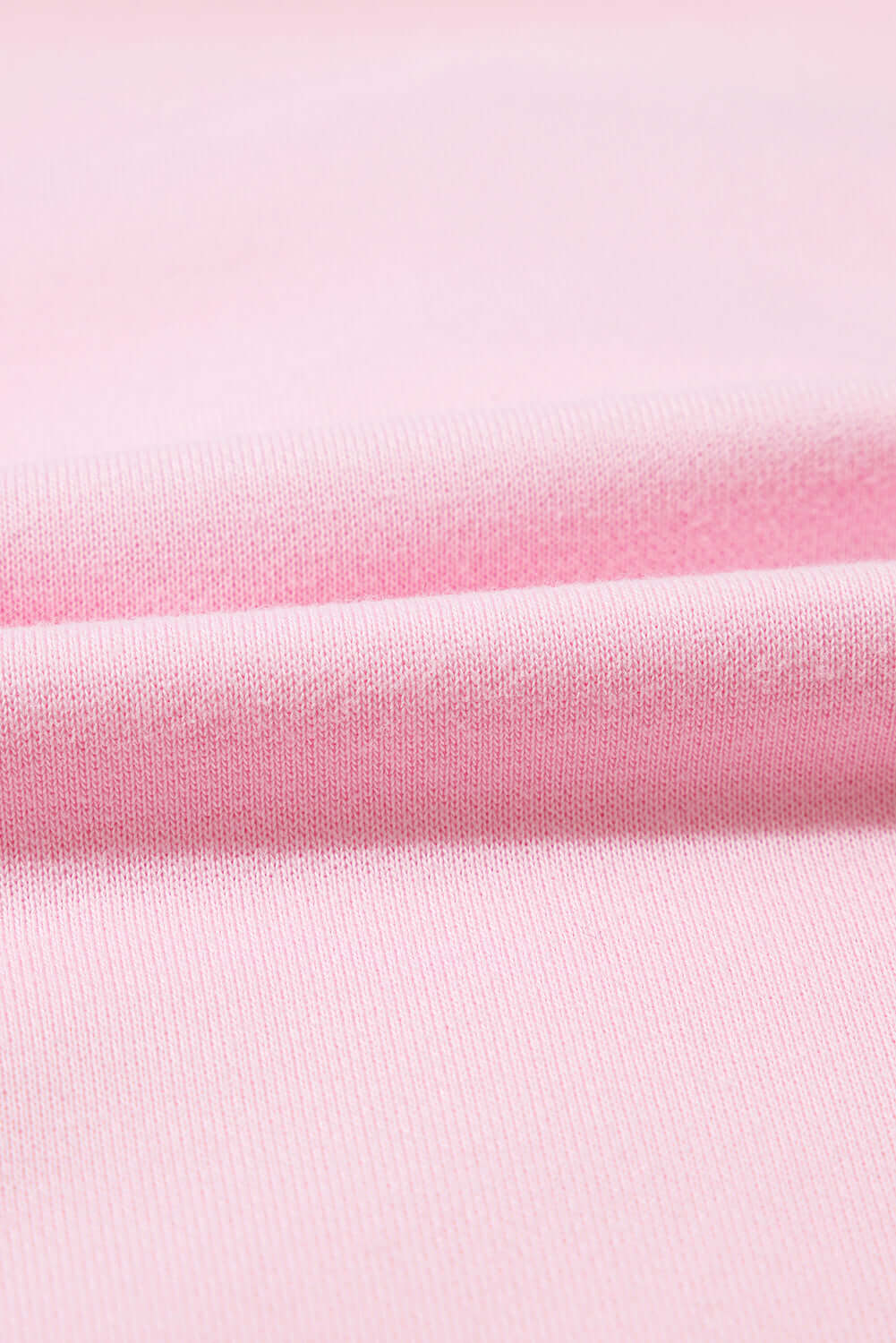 Soft fabric close-up of THE BOWTIQUE Top (pink) showcasing its baby pink color and texture.