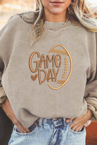 LOVE OF THE GAME CORDED CREW featuring 'Game Day' design and football accent on comfy oversized beige sweatshirt.