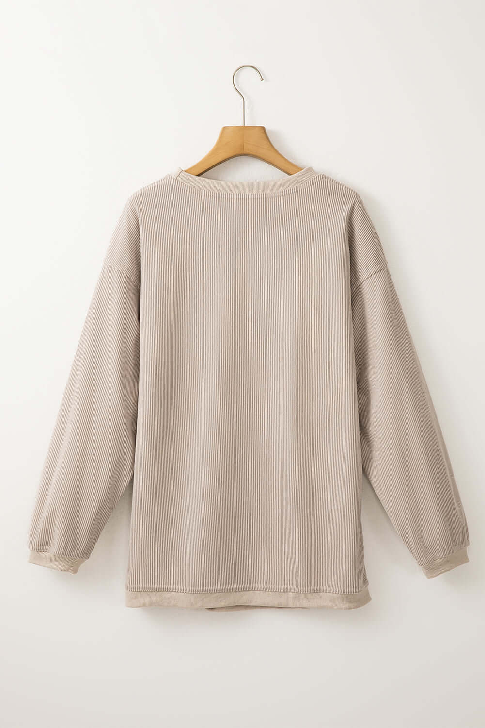 Back view of the LOVE OF THE GAME CORDED CREW in Harvest Beige, showcasing its cozy ribbed texture and oversized fit.