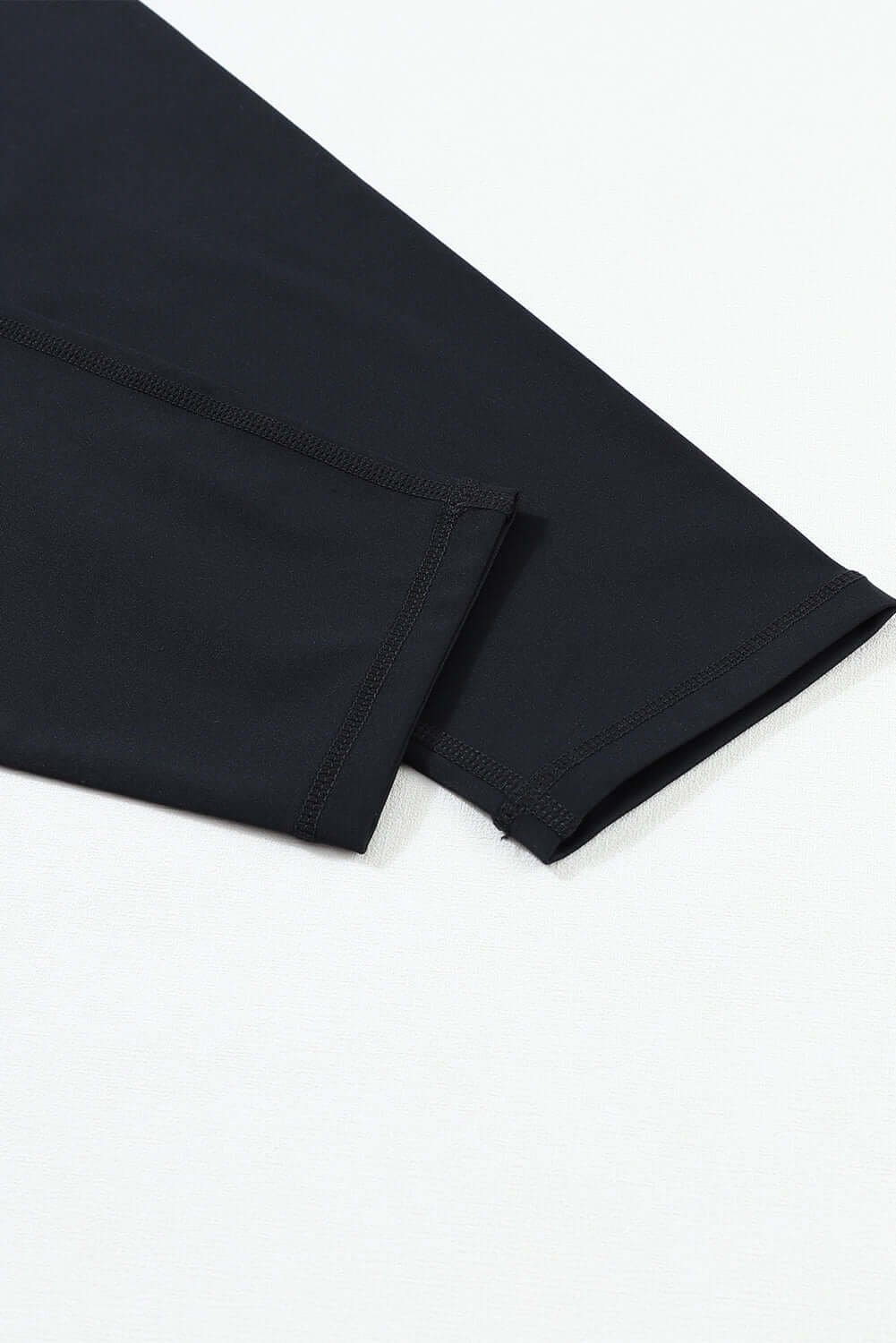 Close-up of the seamless cuff of WALK AWAY leggings by Vivian-Lu, showcasing soft black fabric and perfect stitching.