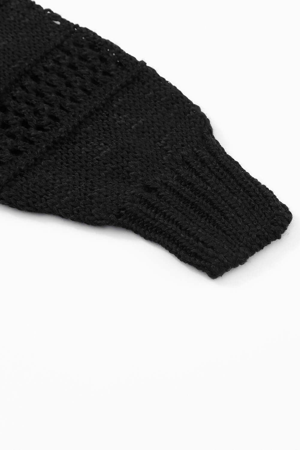 Close-up of the sleeve detail of the Blackout Bliss Cardigan, featuring a black cable-knit design.