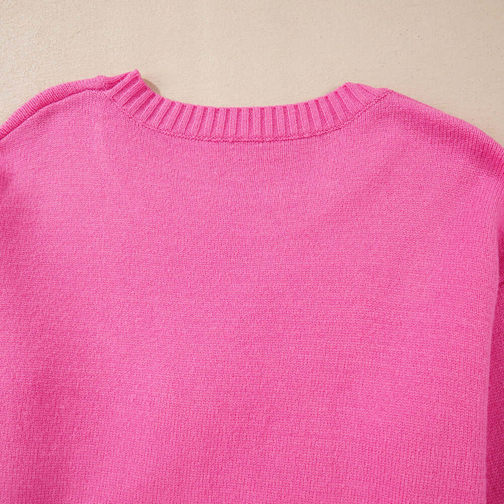 Back view of the TRIP TO REMEMBER Sweater in vibrant pink, showcasing its relaxed fit and soft knit texture.