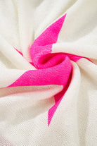 Close-up of the textured fabric featuring vibrant pink stars on the STARSTRUCK SWEATER, showcasing its playful colorblock design.