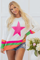 Model wearing STARSTRUCK SWEATER with bold star design and colorful stripes, styled with denim shorts.