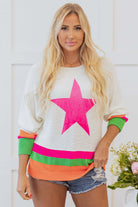 Model wearing STARSTRUCK SWEATER featuring vibrant colorblock stripes and a bold star design.