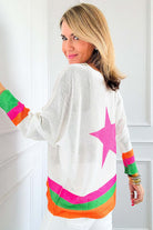 Back view of a model wearing the STARSTRUCK SWEATER, featuring a vibrant colorblock design and a large pink star.