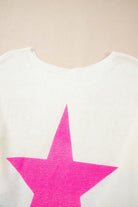 Back view of the STARSTRUCK SWEATER showcasing a bold pink star design against a soft white background.